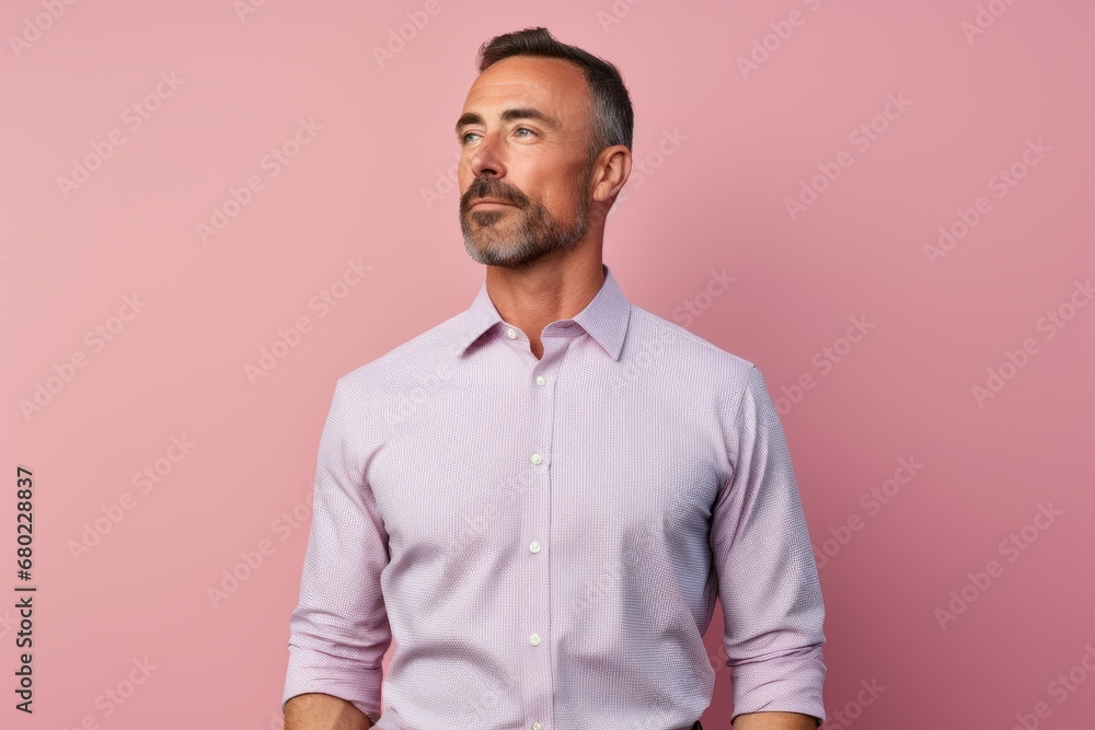 Portrait of a tender man in his 40s sporting a technical climbing shirt against a solid pastel color wall. AI Generation Portrait of a tender man in his 40s sporting a technical climbing shirt against a solid pastel color wall. AI Generation
