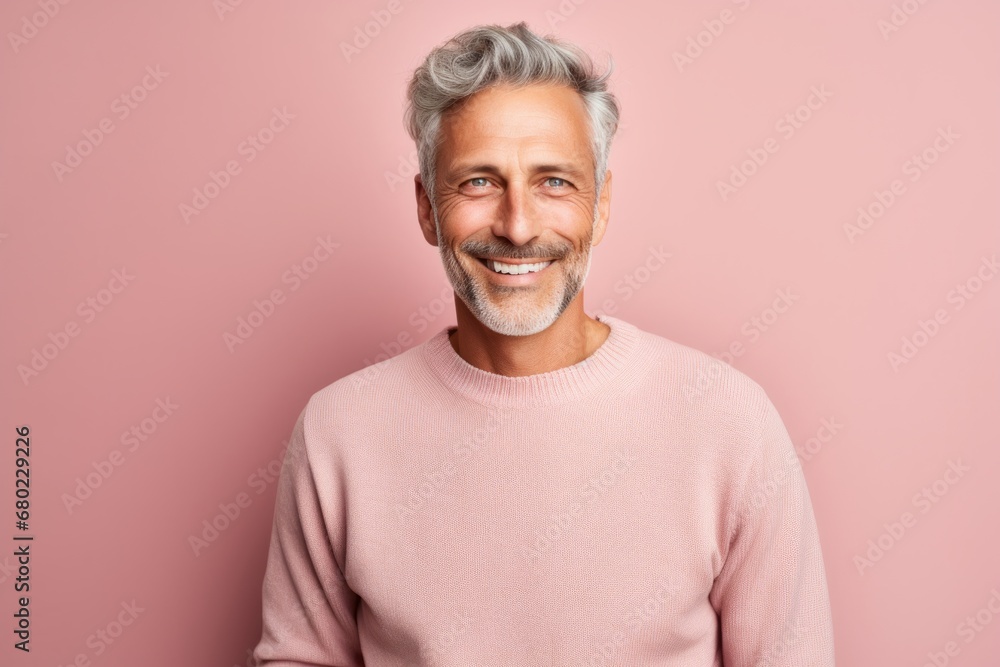 Portrait of a smiling man in his 50s dressed in a warm wool sweater against a solid pastel color wall. AI Generation Portrait of a smiling man in his 50s dressed in a warm wool sweater against a solid pastel color wall. AI Generation