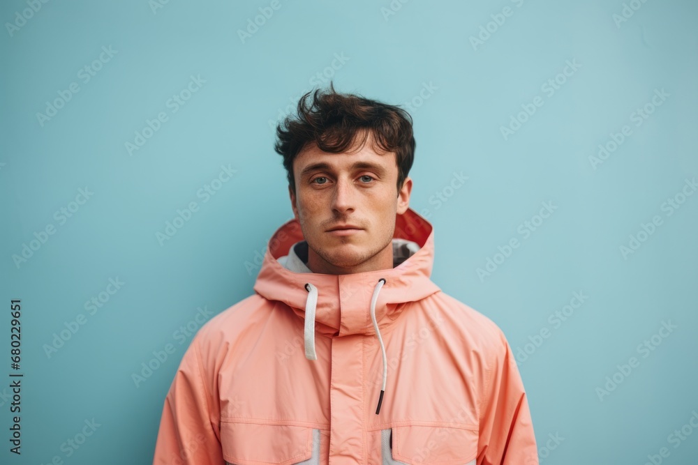 Portrait of a glad man in his 20s wearing a windproof softshell against a solid pastel color wall. AI Generation Portrait of a glad man in his 20s wearing a windproof softshell against a solid pastel color wall. AI Generation