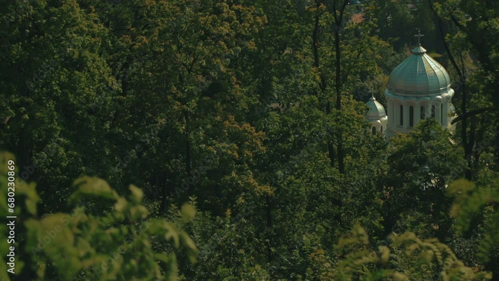An orthodox white church surrounded by dense woods, symbolizing faith and spirituality An orthodox white church surrounded by dense woods, symbolizing faith and spirituality