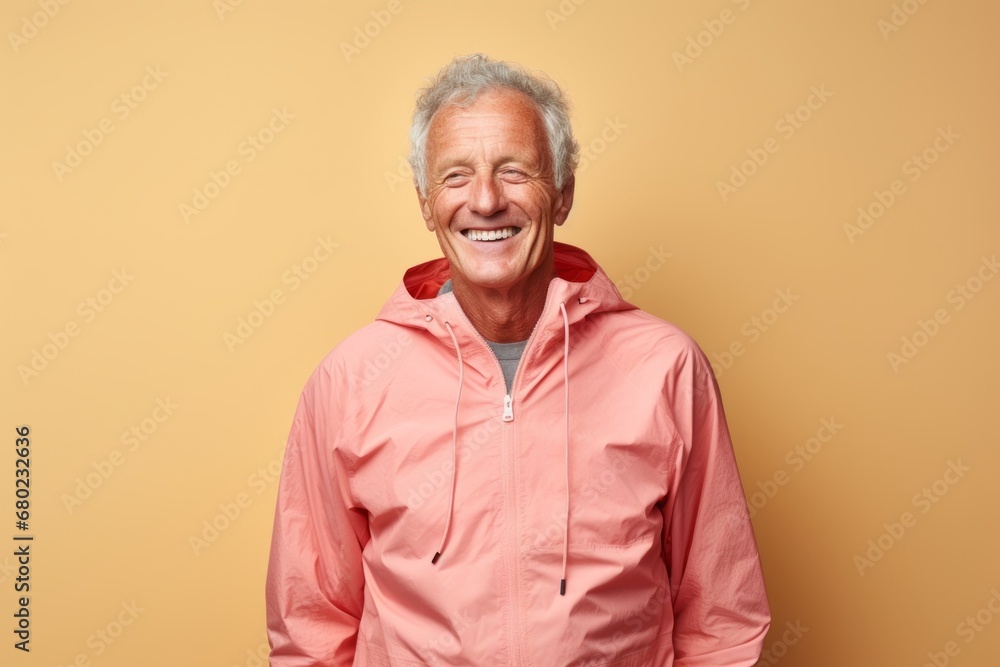 Portrait of a happy man in his 70s wearing a functional windbreaker against a light wood minimalistic setup. AI Generation Portrait of a happy man in his 70s wearing a functional windbreaker against a light wood minimalistic setup. AI Generation