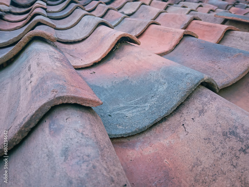 Close up of a house roof tile arrangement made of clay that protects the house from natural weather.
