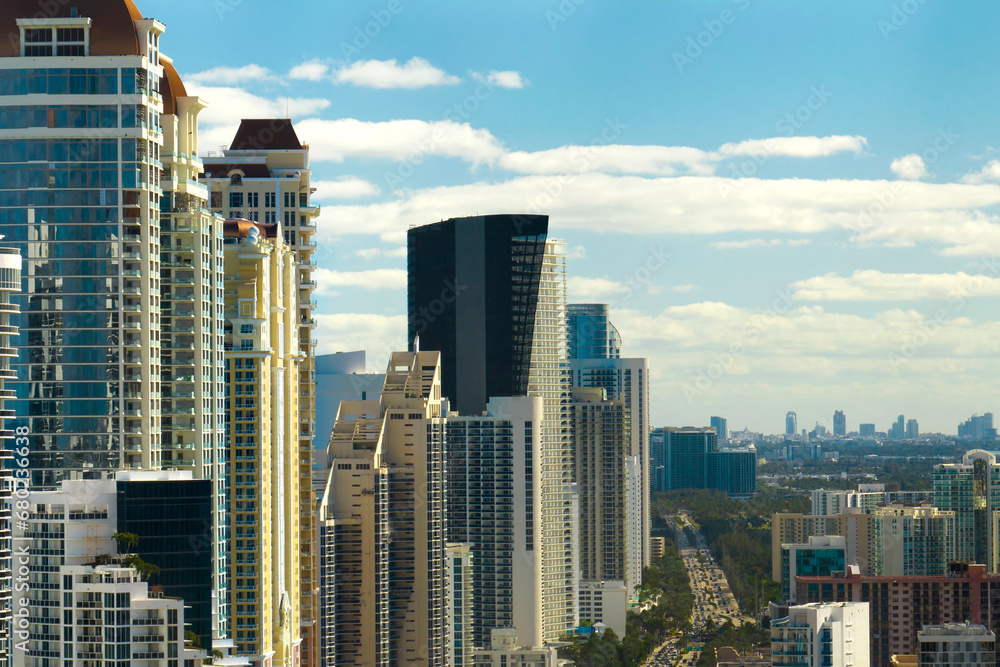 Aerial view of Sunny Isles Beach city with luxurious highrise hotels and condos on Atlantic ocean shore. American tourism infrastructure in southern Florida