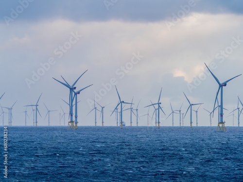 Offshore and Onshore Windmill farm Westermeerwind, Windmill park in the Netherlands with huge large wind turbines, group of windmills for renewable electric energy photo