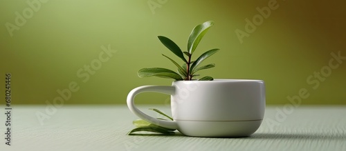 background, an isolated hand delicately holds a green tea leaf, its vibrant hue contrasting against the white porcelain cup. This organic, Indian or Chinese plant is a key ingredient traditional photo