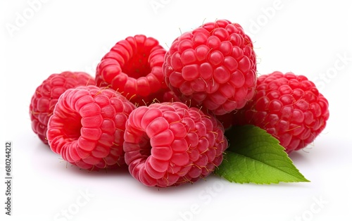 Bunch of raspberries with green leaves on isolated white background