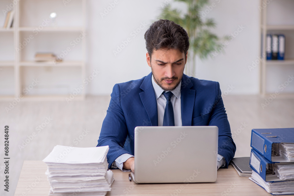 Young male employee working in the office Young male employee working in the office