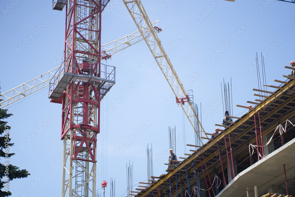 The construction site of a large residential commercial building, several floors have already been built. Metal construction on the background of the sky. With space to copy. High quality photo The construction site of a large residential commercial building, several floors have already been built. Metal construction on the background of the sky. With space to copy. High quality photo