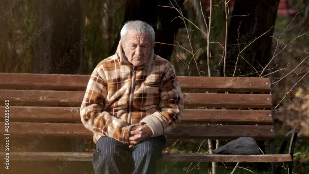 Elderly man on a park bench. Mature adult male relax on bench. Old man in autumn park. Elderly man on a park bench. Mature adult male relax on bench. Old man in autumn park.