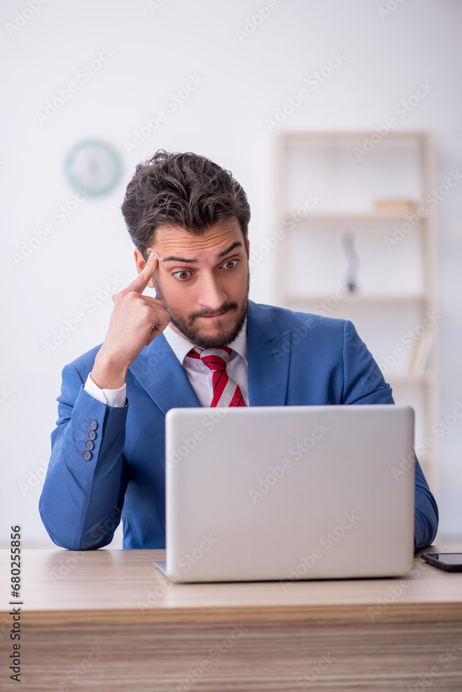 Young male employee working in the office Young male employee working in the office