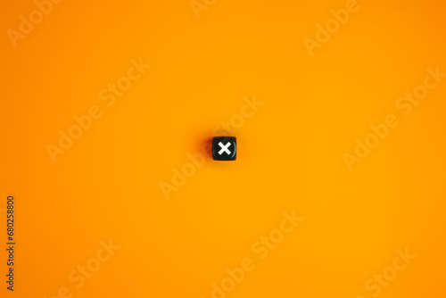 Cross mark or x mark symbol on wooden block, Rejection and cancellation, Negative decision, Error or cancellation, Cross sign for rejection concept on black background photo