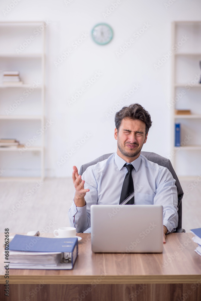 Young male employee working in the office Young male employee working in the office