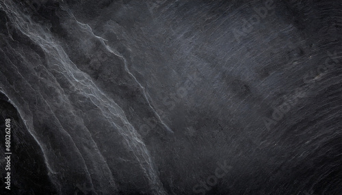 dark grey black slate background or natural black stone texture