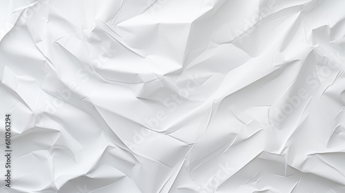A crumpled white paper texture with multiple creases and folds creating an abstract pattern.