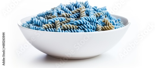 The closeup shot of a blue spiral-shaped fusilli pasta in a white bowl showcases the organic and wholemeal nature of this biodynamic Italian food, emphasizing its nutritious value and rich photo