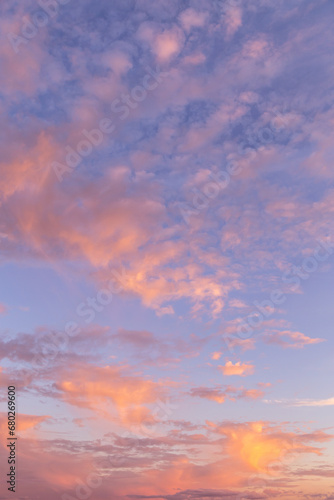 Beautiful blue morning sky with many little small fluffy clouds in sunlight and yellow orange sunset sunrise background texture