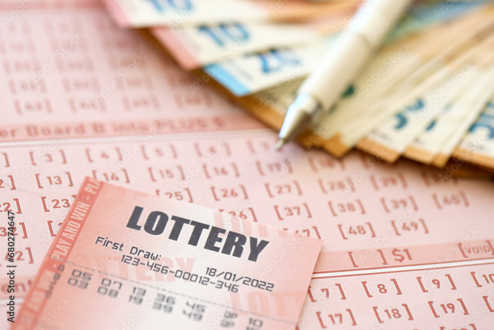 Lottery ticket and gambling receipt on table with pen and European Union euro money bills close up Lottery ticket and gambling receipt on table with pen and European Union euro money bills close up