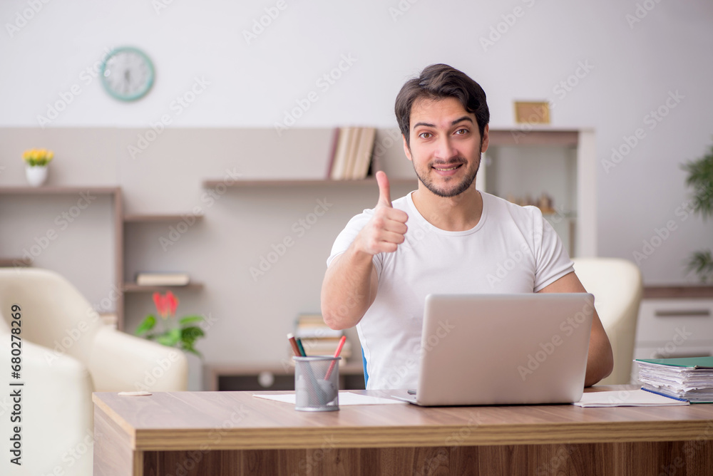 Young male employee working from home during pandemic Young male employee working from home during pandemic