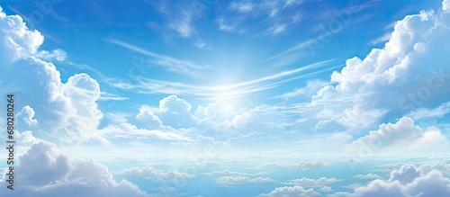 Fototapeta Naklejka Na Ścianę i Meble -  In the abstract design of a summer landscape, the light of the sun illuminates the breathtaking nature, as white clouds paint the blue sky with a stunning array of colors, creating a beautiful texture