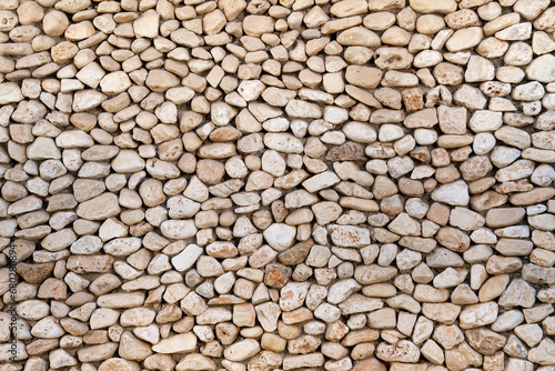 Background with a wall made of oval-shaped stones