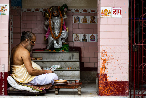 pandit sitting in front of hanuman ji and chanting 