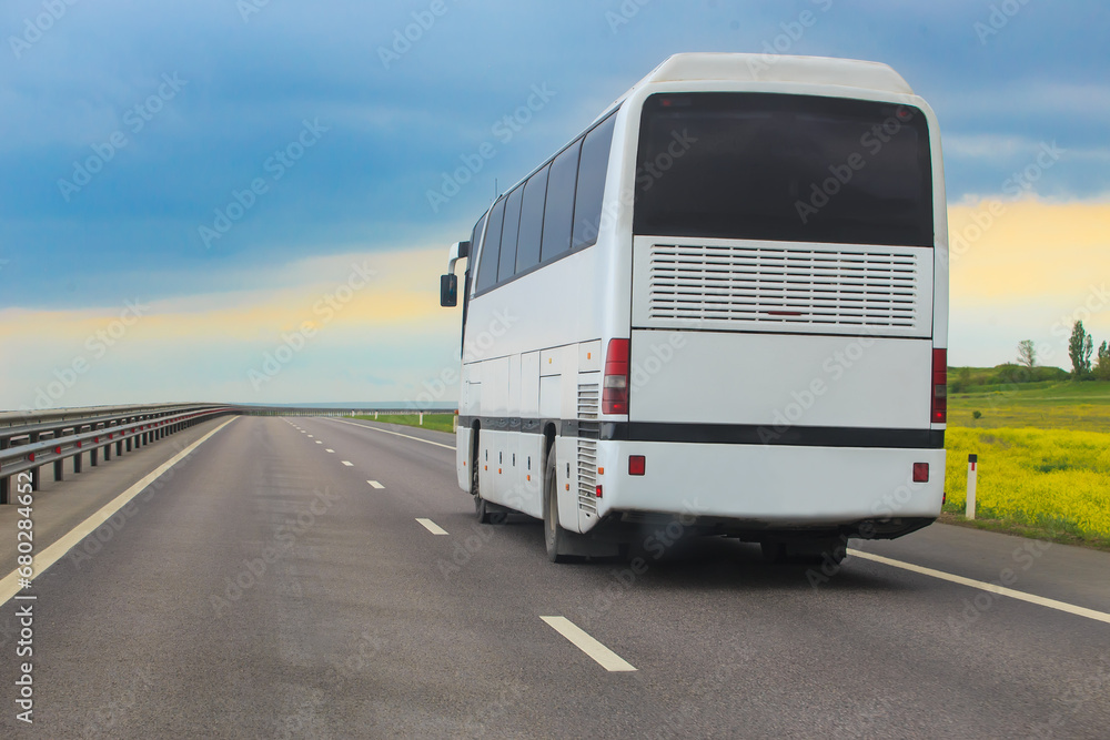 Tourist bus moves along a country road Tourist bus moves along a country road