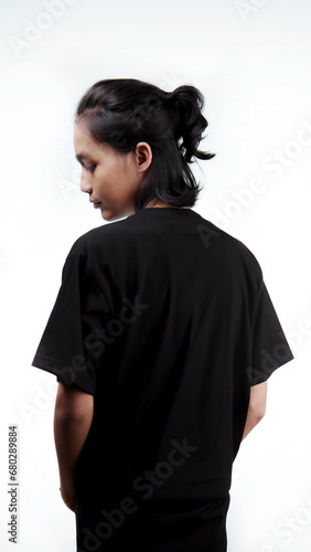 Clothing model. Young Asian man with long curly hair close up shot isolated on white. Asian young man wearing plain black t-shirt isolated on white background. As if he were modeling a plain t-shirt.