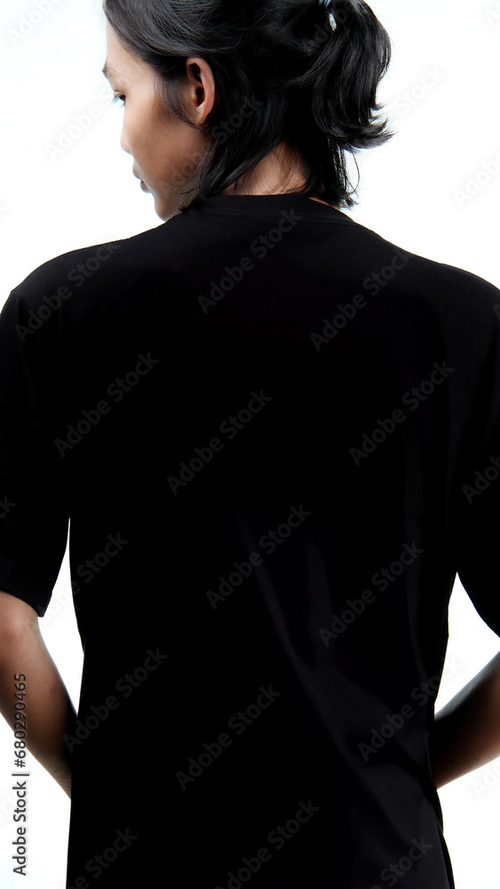 Clothing model. Young Asian man with long curly hair close up shot isolated on white. Asian young man wearing plain black t-shirt isolated on white background. As if he were modeling a plain t-shirt.
