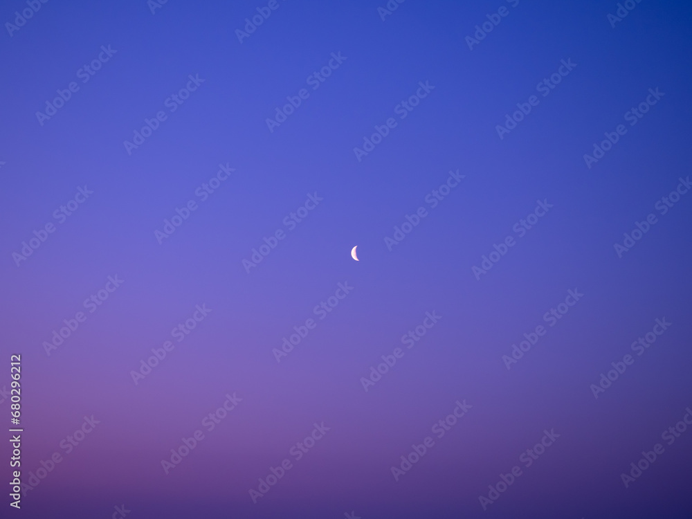 Crescent moon in the early morning over a field Crescent moon in the early morning over a field