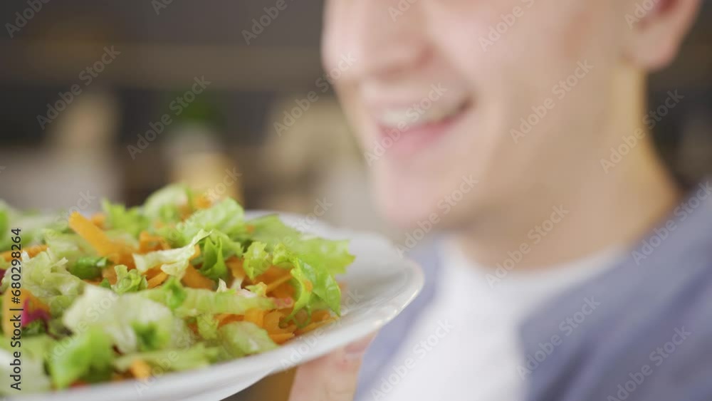 Man looking at salad with appetite. Man looking at salad with appetite.