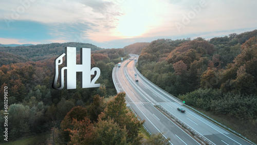Aerial view of traffic on road at sunset with hydrogen concept - Visual H2 effect symbol and 3D graphic - Futuristic innovation photo