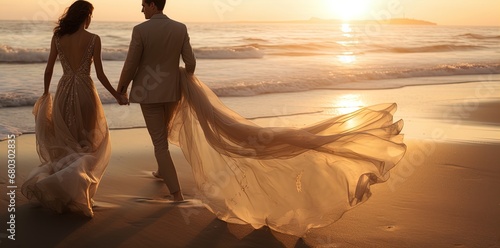 Sunset stroll: A couple in elegant attire walks along the beach, romance in the sea breeze. photo