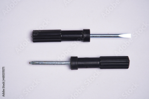 Plus and minus screwdrivers photographed close up on a white background