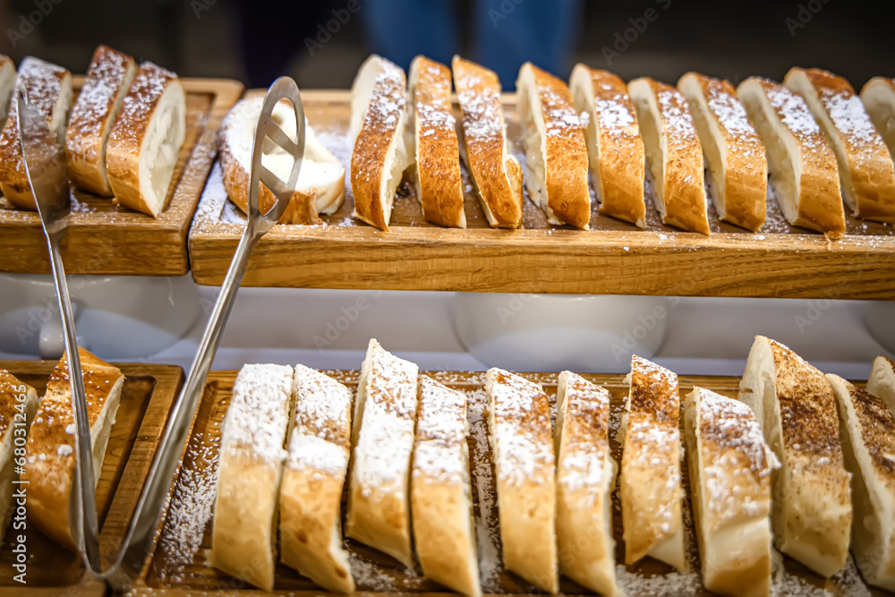 Slices of apple strudel on display in a bakery