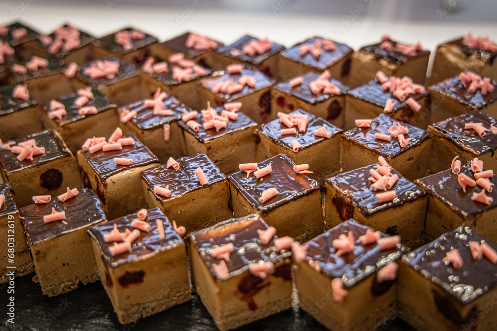 Delicious chocolate cakes on display in a pastry shop. Selective focus. Delicious chocolate cakes on display in a pastry shop. Selective focus.