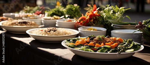 At the Asian festival, a white tablecloth adorned the table, covered in plates of healthy Chinese meals like rice and stir-fried vegetables with lotus leaves, accompanied by gourmet snacks such as egg