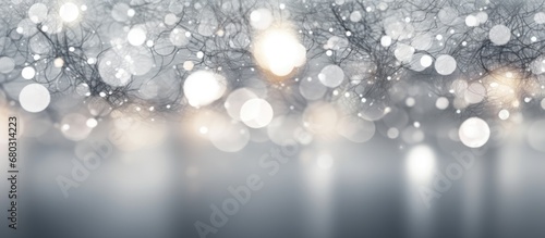 The abstract white background showcases an intricate pattern of gray bokeh lights.