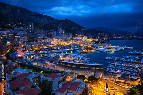 Aerial view of Monaco Monte Carlo harbour and illuminated city skyline in the evening blue hour twilight. Monaco Port night view with luxurious yachts photo