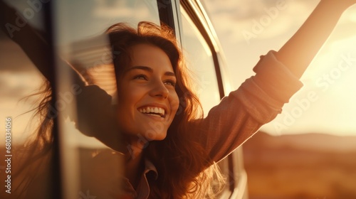 Happy woman stretches her arms while sticking out car window. Lifestyle, travel, tourism, nature, car, person, travel, females, summer, happy