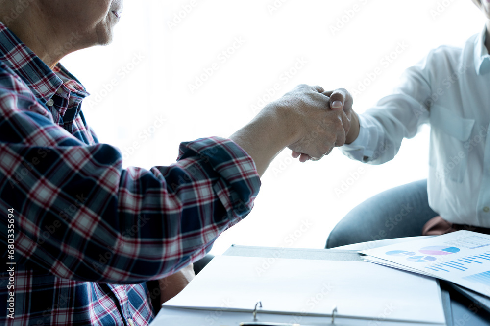 Freelance business people are shaking hands in congratulations