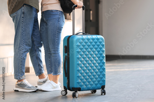 Long-distance relationship. Couple with luggage near house entrance outdoors, closeup
