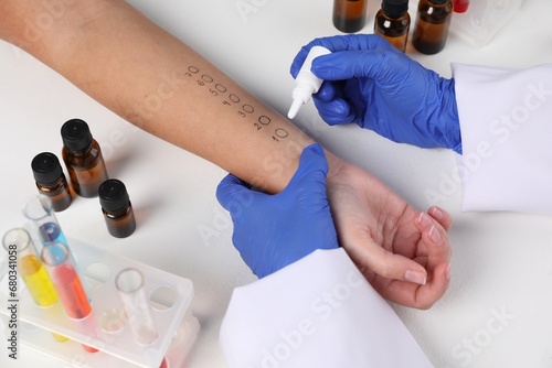 Doctor doing skin allergy test at light table, closeup