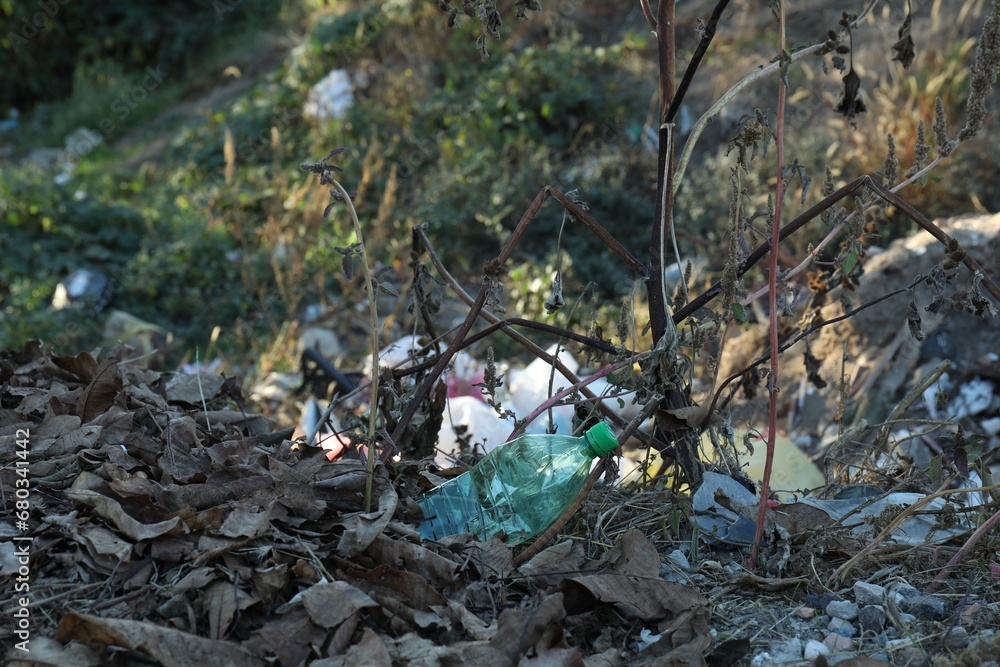 Fototapeta premium Different plastic garbage outdoors. Environmental pollution concept