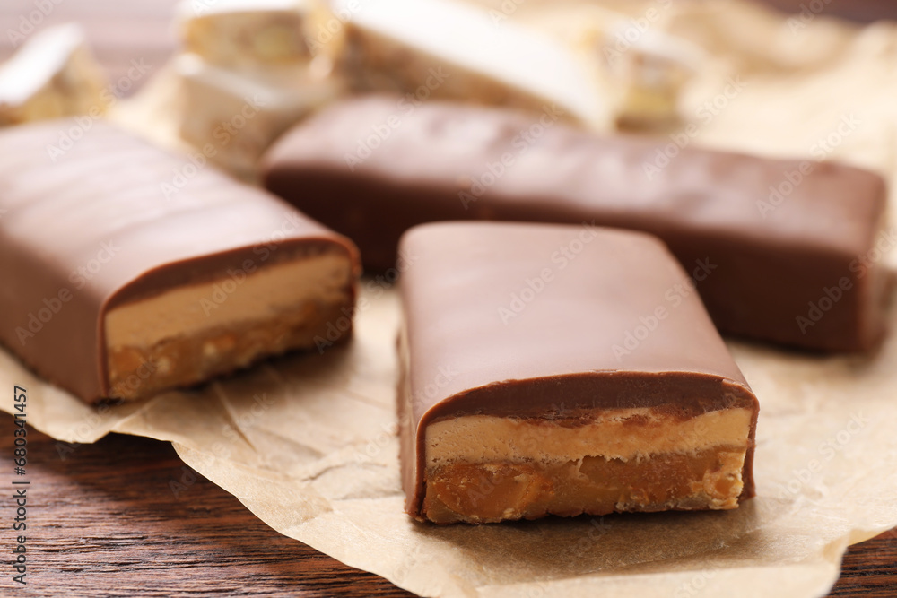 Pieces of tasty chocolate bars with nougat on table, closeup Pieces of tasty chocolate bars with nougat on table, closeup