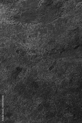 Texture of dark grey stone surface as background, closeup