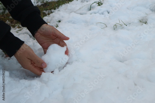 Woman's hands playing in the snow in Nagano, Japan