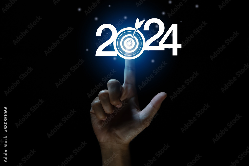 Fototapeta premium touching to Goal and target of business in new year 2024. Planning, opportunity, challenge and business strategy in new year 2024. Development to success and motivation. 