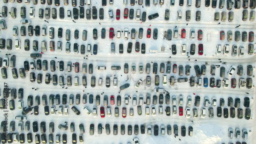 Aerial view of many cars parked for sale and people customers walking on car market or parking lot in winter Aerial view of many cars parked for sale and people customers walking on car market or parking lot in winter