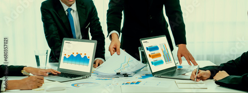 Business people in group meeting in formal attire share idea discussing report for company profit in creative workspace for start up business shot in close up view on group meeting table . Oratory .