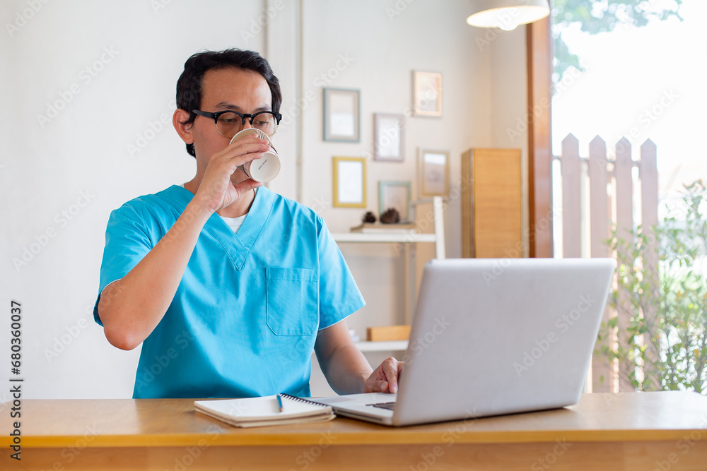Male nurse takes a break outside of a coffee shop. Male nurse takes a break outside of a coffee shop.